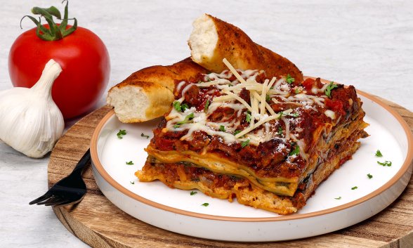 A slice of lasagna on a plate.