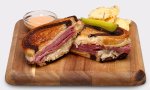 Reuben sandwich on a cutting board.