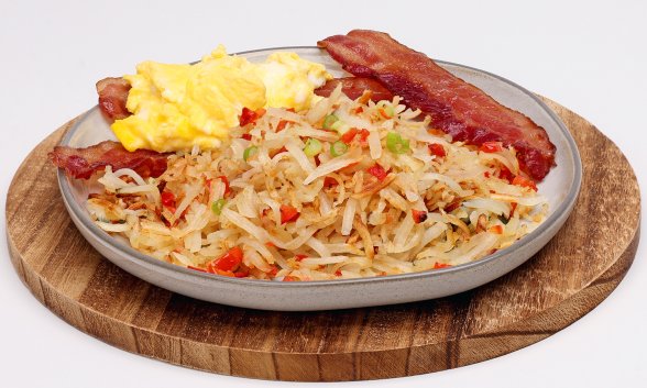 Hash browns with bacon and scrambled eggs on a plate.
