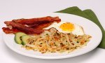 Herbed Hash Brown Patties with bacon and egg on a plate.