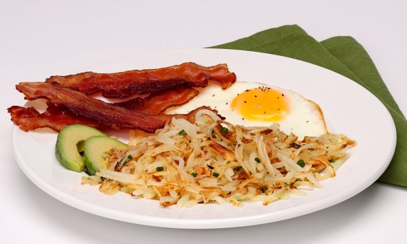 Herbed Hash Brown Patties with bacon and egg on a plate.