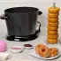 The DualDaddy electric deep fryer on a kitchen counter. Deep fried donuts are to the right and in the foreground.
