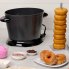 The DualDaddy electric deep fryer on a kitchen counter. Deep fried donuts are to the right and in the foreground.