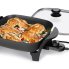The 11-inch Electric Skillet with the cover off and chicken cooking inside.