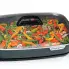 Green beans and peppers cooking in the 16-inch Electric Slimline Skillet with the cover on.