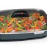 Green beans and peppers cooking in the 16-inch Electric Slimline Skillet with the cover on.