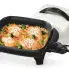 The 11-inch Electric Skillet with the cover off and food cooking in the pan.