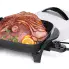 The 11-inch Electric Skillet with the cover off and sliced ham in the pan.