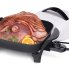 The 11-inch Electric Skillet with the cover off and sliced ham in the pan.