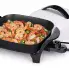 The 11-inch Electric Skillet with the cover off and shrimp cooking in the pan.