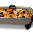 The 16-inch Electric Skillet with the cover on and Jambalaya cooking in the pan.