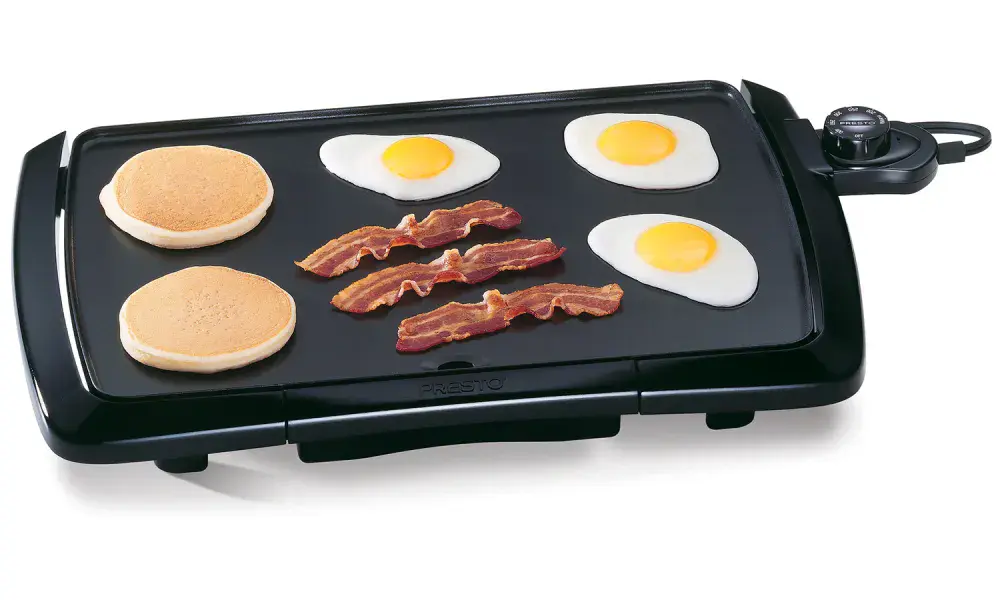 07047 Cool-touch Griddle cooking pancakes, bacon, and fried eggs.