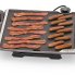 The Tilt-n-Fold Family-size Electric Griddle cooking bacon and breakfasr sausages.