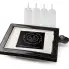 The PanGogh Pancake Art Griddle with an art template on the griddle and four empty batter bottles.