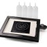 The PanGogh Pancake Art Griddle with an art template on the griddle and four empty batter bottles.