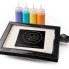 The PanGogh Pancake Art Griddle with an art template on the griddle and four filled batter bottles.