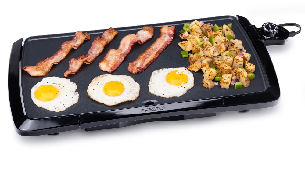 07030 20-inch Cool-touch Electric Griddle with fried eggs, bacon, and hash browns.