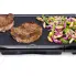 The 20-inch Cool-touch Electric Griddle with grilled steak and vegetables.
