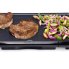 The 20-inch Cool-touch Electric Griddle with grilled steak and vegetables.