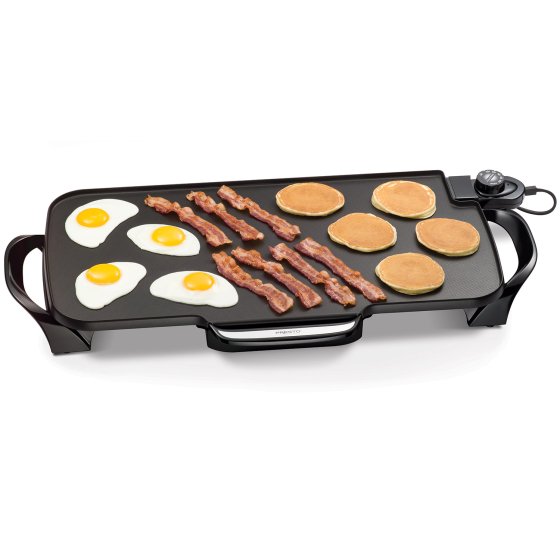 07061 22-inch Electric Griddle cooking fried eggs, bacon, and pancakes.
