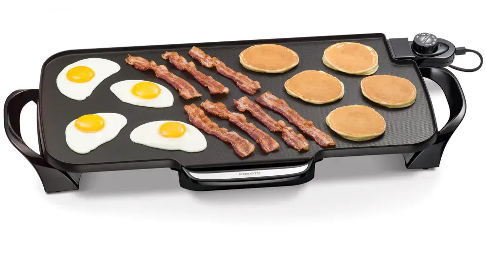 07061 22-inch Electric Griddle cooking fried eggs, bacon, and pancakes.