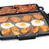 The Cool-touch Electric Griddle/Warmer Plus cooking hash browns, French toast, and fried eggs with bacon in the tray.