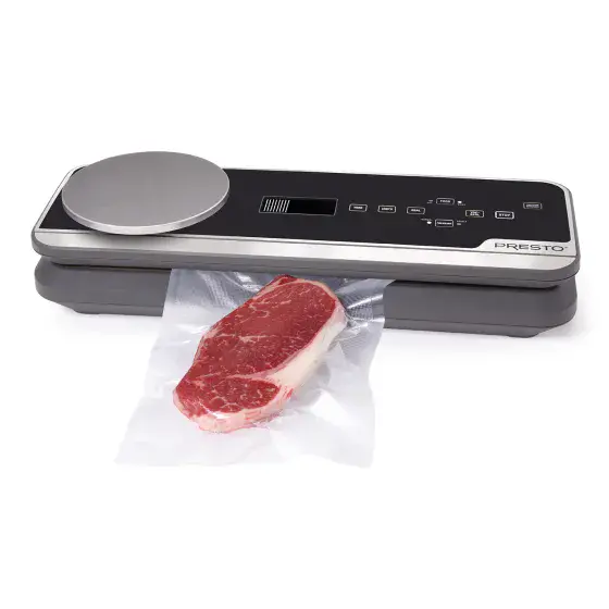 05623 FreshDaddy Vacuum Sealer with Digital Scale sealing a bag containing a steak.