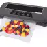 The FreshDaddy Automatic Vacuum Sealer sealing a bag containing fruit.