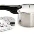 The 4-Quart Aluminum Pressure Cooker with the pressure regulator, cooking rack, and instruction book alongside.