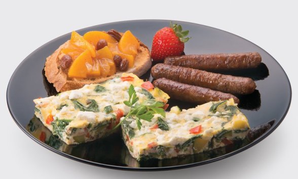 Summer vegetable frittata with peach chutney and breakfast sausage on a plate.