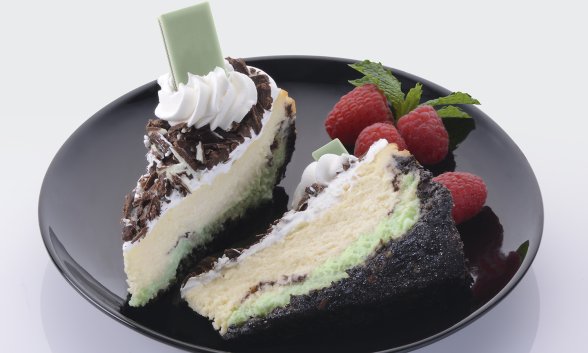 Slices of Vanilla Mint Cheesecake with Dark Chocolate on a plate.