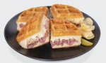 A Reuben stuffed waffle on a plate.