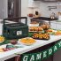 The Nomad Traveling Slow Cooker on a kitchen counter with game day buffet foods.